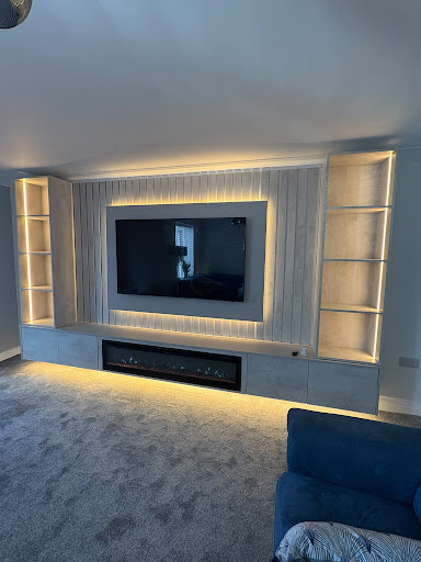 Full-width floating concrete hearth with vertical LED slatted panels